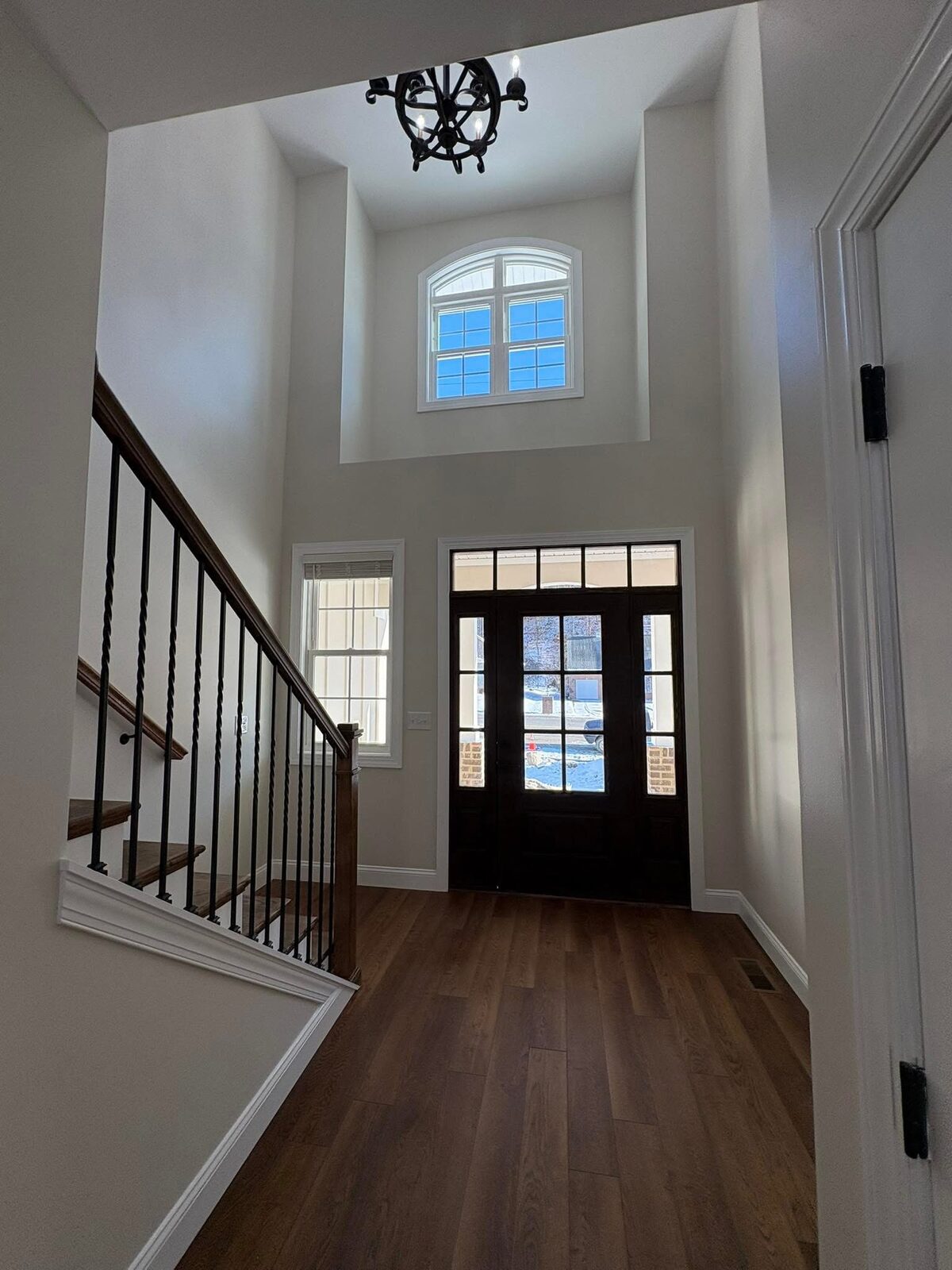 Two-story foyer with iron-baluster staircase