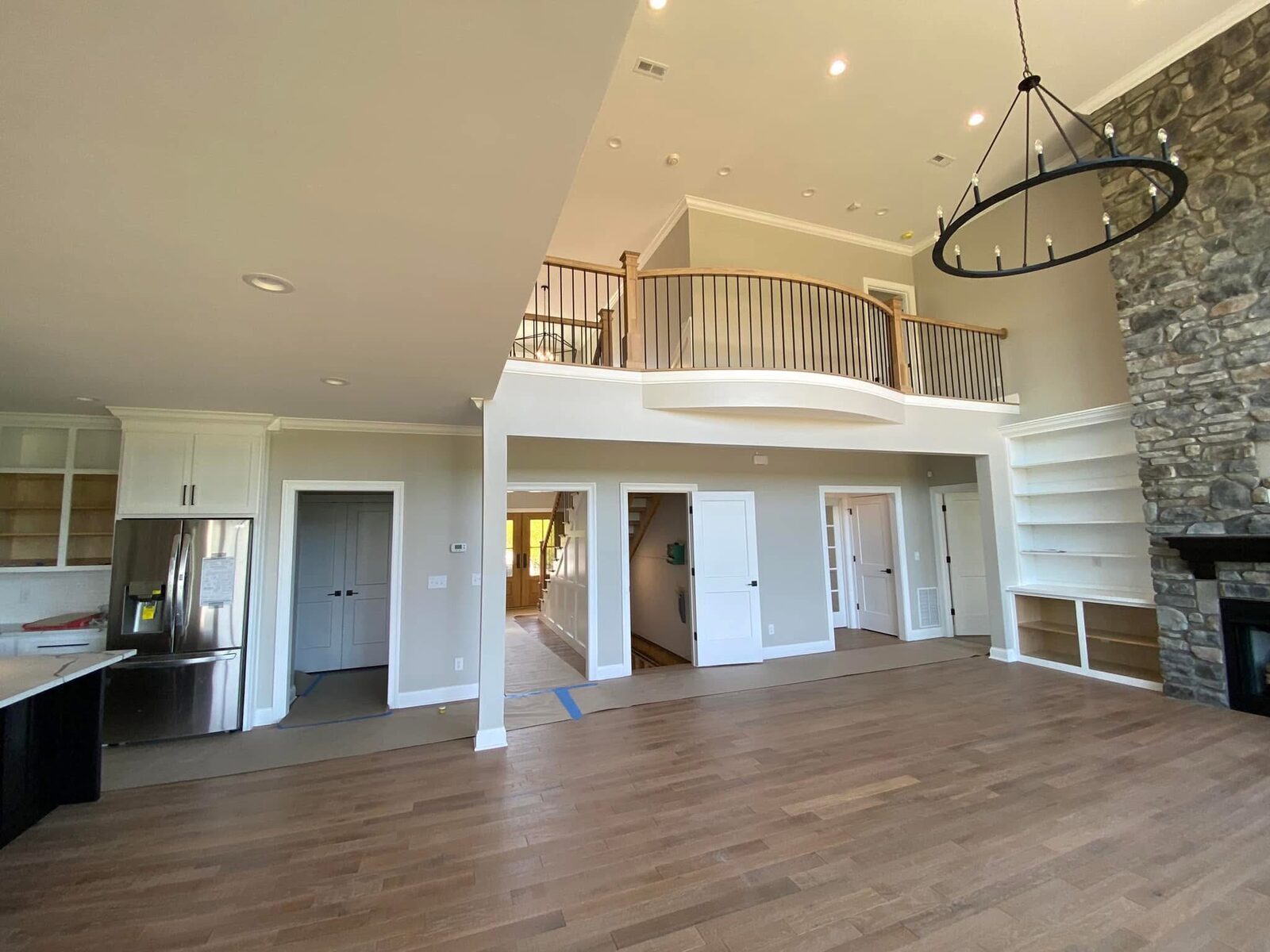 Two-story great room with catwalk and stone fireplace