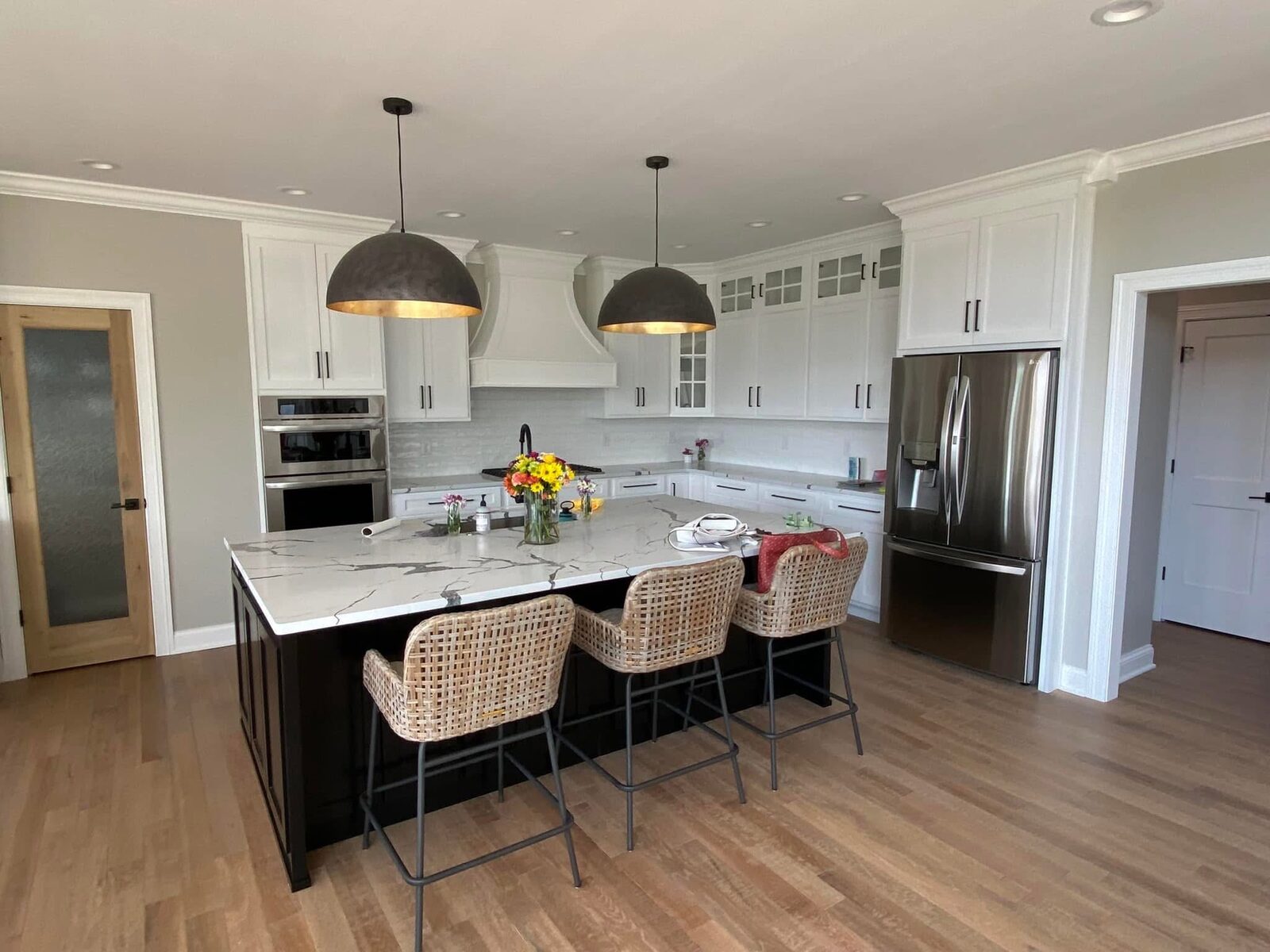 Kitchen island with waterfall counter and bar seating