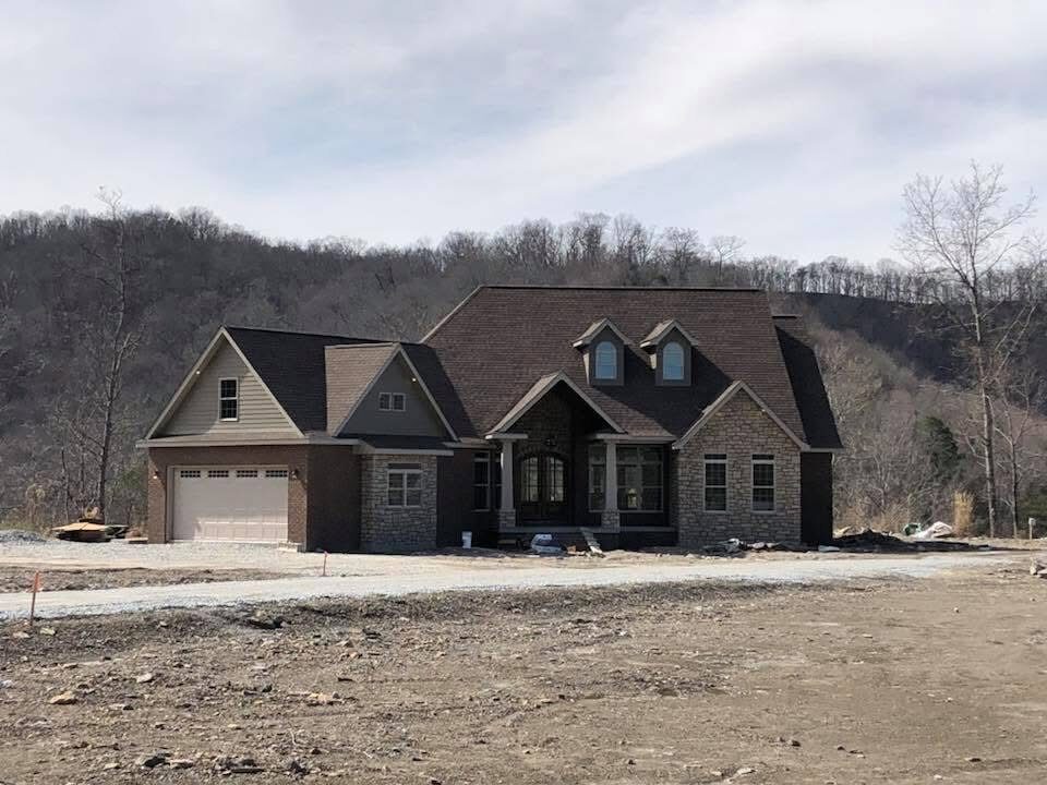 Stone-front custom home nearing completion
