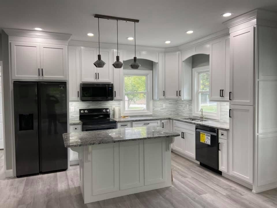Kitchen with quartz island and black appliances