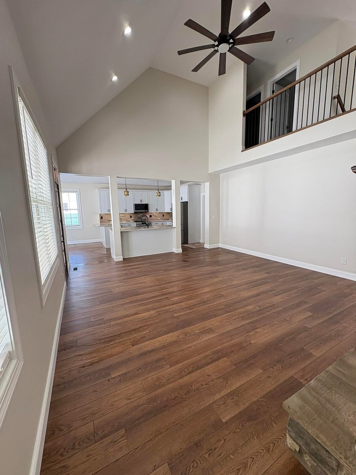 Vaulted great room with hardwood flooring