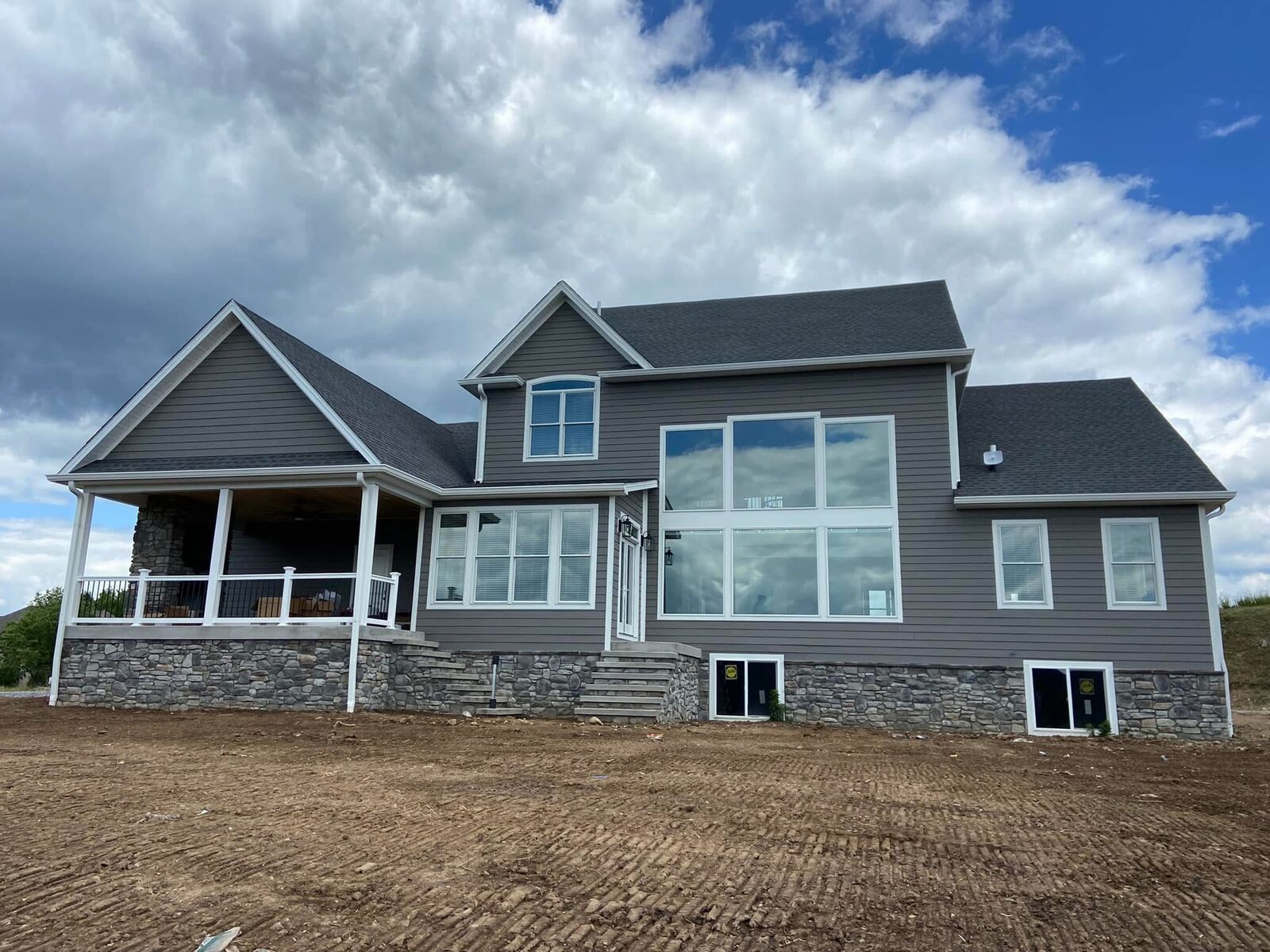 Large custom home with covered porch and stone base